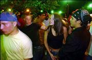 Bar-goers mingle after 2 a.m. closing time outside It's Brothers
Bar and Grill, 1105 Mass. Police say that with the return of Kansas
University students to town after the summer break, scenes like
this on a recent Sunday morning are more prevalent after hours
downtown.