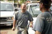 Josef Rantner chats with Larry Tate, Lawrence, another Chaney
employee, Wednesday on the job in downtown Lawrence.