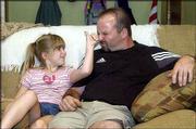 Josef Rantner, right, and his daughter, Isabella, 8, horse around
on the couch in their Lawrence home. Josef, from Austria, is one of
150 people who will become U.S. citizens today during a
naturalization ceremony at the Dole Institute of Politics.