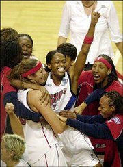 Detroit forward Swin Cash, center, and teammate Ruth Riley, left,
are surrounded by teammates after their win in Game 3 of the WNBA
Finals. The Shock won the title with a 83-78 victory Tuesday over
Los Angeles in Auburn Hills, Mich.