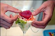 Almost every Lawrence sushi restaurant offers its own specialty.
Sushi Station, 1730 W. 23rd St., has come up with a fish "cocktail"
that contains radish, lettuce, cucumber, lemon, green onion, radish
sprouts, fish eggs, fresh tuna and ponzu sauce in a cocktail glass.