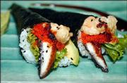 Suken-style hand rolls are a popular item at Sushi Station. The
finger food is wrapped in nori (dried seaweed) and stuffed with:
lettuce, vinegar-seasoned rice, avocado, barbecued freshwater eel,
shrimp tempura, house eel sauce and black sesame seeds.