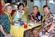 From left, Duane and Leann Dickson and Susan and Bud Stagg, all of
Lawrence, visit during the River City Cosmopolitan Club's 2003
Inaugural Luau. The club is affiliated with the Cosmopolitan
International organization, which aims to find a cure for diabetes.