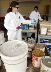 Kathy Richardson, left, and Michelle Crank, both hazardous waste
materials technicians with the Lawrence-Douglas County Waste
Reduction and Recycling Division, unload a delivery of house paint
at the Household Hazardous Waste Collection Facility. Douglas
County residents are encouraged to drop off household hazardous
wastes at the facility to keep them out of the regular trash.
