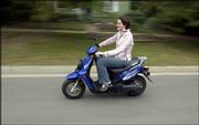 Kansas University senior Falestine Afani Ruzik, co-founder of KU
ScooterHawks, an officially recognized student group for scooter
and mo-ped enthusiasts, enjoys an afternoon cruise on her 2003
Yamaha Zuma Sport Scooter. Lawrence residents both on and off
campus are increasingly turning to scooters as a quick, convenient,
environmentally friendly mode of transportation.