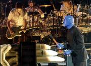 A Blue Man Group member jams on one of the act's many unusual
percussion devices, backed by a live band on the Complex Rock Tour.
