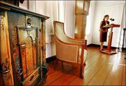 Dee Patberg, president of the Historical Society of Princeton,
talks about the items belonging to Albert Einstein that have been
donated to the society and will soon be on display. The items shown
include an ornate oak cabinet, a chair and a grandfather clock.