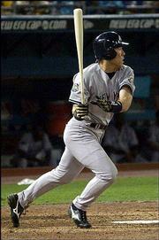 New York's Hideki Matsui watches his single break a 1-all tie,
scoring Derek Jeter in the eighth inning.