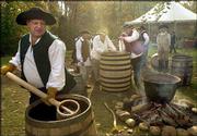 David Pickerell, master distiller for Maker's Mark, carries water
to be boiled as he and other master distillers gather on the
archaeology site of George Washington's distillery. The distillers
worked in Mount Vernon, Va., Tuesday in efforts to recreate the
founding father's popular whiskey recipe.