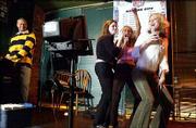 From left, DJ Tom Hinson looks on as Amanda Green, Allison Maher
and Danielle Perrin sing "Baby Got Back" recently at Molly McGee&squot;s.