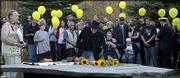 Workshop host and Pulitzer-Prize winner Eddie Adams, center, lays
down a sunflower in honor of photojournalists killed during the
Vietnam War. Adams was host to his 16th annual Eddie Adams Workshop
in mid-October near Jeffersonville, N.Y. Pictured at Adams'
immediate left is photojournalist Nick Ut, who received a Pulitzer
Prize for his photograph of a young Vietnamese girl running naked
after being burned by napalm; seated second from Adams' right is
Joe Rosenthal, who also received a Pulitzer Prize for his
photograph of Marines raising the American flag on Mount Suribachi,
Iwo Jima. Adams received his Pulitzer for his 1968 photograph of
Gen. Nguyen Ngoc Loan executing a Viet Cong prisoner in Saigon.