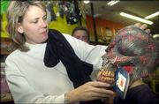 Jannel Munk, Lawrence, adjusts her son, Conner's monster mask. The
two were shopping Saturday afternoon for at Fun 'n Games, 816
Massachusetts St., for Halloween costumes.