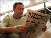 Rescued miner Valery Grabovsky reads the daily Izvestia in a
hospital in Novoshakhtinsk, southern Russia. Grabovsky was among
the Zapadnaya miners trapped in the mine when water burst in from
an underground lake.