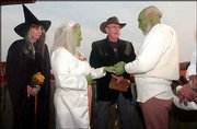 Patty and Bob Gibbons tie the knot in a Halloween ceremony at Wells
Overlook Park. The couple dressed as Shrek, a green ogre from the
2001 Dreamworks film "Shrek." Betty Caldwell, left, of Topeka, was
the maid of honor. The Rev. Gary Thomas, center, of First United
Methodist Church of Linwood, married the couple.