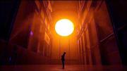 Danish environmental sculptor Olafur Eliasson stands in the Turbine
Hall at the Tate Modern art museum in London and looks up at his
artwork, "The Weather Project." Eliasson has used mirrors, light,
sound and mist to create a monochrome space that exposes and
confronts the visitor.