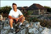 Journal-World photographer Richard Gwin sits for a portrait in
Gibara, a fishing village on the northeast coast of Cuba. Gwin has
taken a dozen or so trips to the island during the past decade and
a half. This shot was taken in the late 1990s.