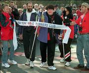 Zoe Koplowitz, center, who suffers from multiple sclerosis, crosses
the finish line of the New York City Marathon on Nov. 4, 1996.
Koplowitz, who usually takes more than 24 hours to finish the
26.2-mile course, today will participate in her 16th New York City
Marathon.
