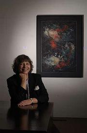 Artist and arts advocate Diana Dunkley won a Phoenix Award for
Visual Arts. Dunkley is pictured Tuesday at Fields Gallery, 712
Mass., next to one of her works on display.