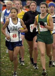 Blue Valley North's Jana Gwinn, left, Shawnee Mission South's
Connie Abbott, center, and Free State's Alysha Valencia set the
pace in the girls Class 6A state cross country race. Gwinn won, and
Valencia placed sixth in the event Saturday at Rim Rock Farm.