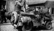 From left, Harry Goldsmith, Lawrence Czarnota, Cecil New and Glenn
Kappelman bring two captured Germans, sitting on the front hood,
into a Main River village. The photo was taken March 28, 1945, east
of Offenbach, Germany.
