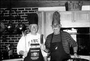 Mel Deutsch, left, and Dave Billings, two Lawrence sportsmen who
have been friends since 1989, play host to an annual "wild game
feed" for family and friends that features dishes incorporating the
game they&squot;ve bagged during hunting season. The men are ready to
cook in this photo, taken during a game feed two years ago at
Billings&squot; house.