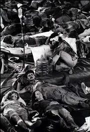 Actors portraying victims of a nuclear explosion near Lawrence are
spread out across the floor of Allen Fieldhouse.
