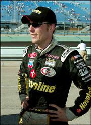 Jamie McMurray stands outside his car after winning the pole for
the Ford 400. McMurray qualified for the pole position Friday at
Homestead-Miami Speedway in Homestead, Fla.