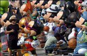 Dan Bustos, left, an artist with the Minnesota-based design and
sculpting studio TivoliToo, admires his handiwork on an Elton
John-designed Mickey Mouse statue as fellow artist Giam Nguyen,
kneeling, paints one of the "75 InspEARations," an exhibit of 75
Mickey Mouse statues. The pair worked Monday at Walt Disney World
Resort in Lake Buena Vista, Fla., to put touches on the
6-foot-tall, 700-pound statues in preparation for today&squot;s
festivities to honor Mickey Mouse&squot;s 75th anniversary.