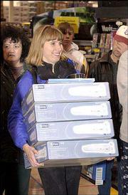 Lisa Gay, of Lawrence, cashed in on some deals at Best Buy and
loaded up on DVD players. In a post-Thanksgiving tradition, bargain
hunters were out in droves early Friday to begin their Christmas
shopping.