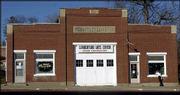 A passer-by peeks into what organizers hope will become an arts and
cultural center in downtown Baldwin. Once a lumberyard, the
facility would house a theater, kitchen, four classrooms, a retail
gallery space and possibly artists' studios.