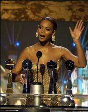 Beyonce Knowles accepts her award for new female artist of the
year. She also was awarded new R&B artist, Hot 100 female
artist and a special Hot 100 award at Wednesday's ceremony.