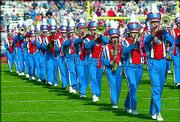 The Kansas University marching band performs before this year's
KU-Missouri game at Memorial Stadium. A KU alumni group from Topeka
has undertaken an effort to raise money to help band members shed
their 1978 uniforms for new duds.
