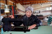 Violet Blowers uses a sewing machine set up in her hangar to make
cloth parts for an antique airplane. Blowers has sewn flight
jackets for U.S. presidents.