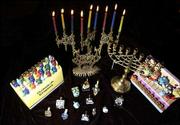 Menorahs, a special candelabrum used during Hanukkah, come in many
varieties and can be traditional or fun. Dreidels, a toy similar to
a spinning top used in games by children at Hanukkah, are displayed
in front.