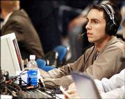 Former Jayhawk Brett Ballard takes a break during his radio
broadcast of the KU-Nevada game. Ballard was filling in for veteran
color man Max Falkenstien, who was in Orlando, Fla., to call
today's Tangerine Bowl.