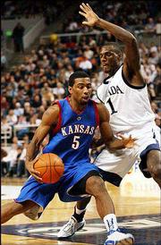 KU junior guard Keith Langford, left, drives against Nevada's Kirk
Snyder. Snyder scored 29 points, leading all scorers, in the Wolf
Pack's 75-61 win.