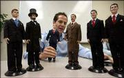 Jesse Combs, president of Toy Presidents Inc., holds a doll of
President George W. Bush as he talks about the company's other
figures, at the company's Houston headquarters. The other
presidents shown are, from left, John F. Kennedy, Abraham Lincoln,
Teddy Roosevelt, Bill Clinton and Ronald Reagan. Each presidential
doll wears hand-stitched clothing reminiscent of their era, such as
Lincoln's top hat and Bush's navy suit, red tie and black cowboy
boots adorned with the presidential seal. The dolls also talk; an
embedded computer chip plays 25 different phrases the presidents
uttered during their administrations.