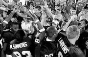 Kansas University football players and fans celebrate after a
Jayhawk victory this season. Kansas went from 2-10 in 2002 to a
berth in the Tangerine Bowl this year.