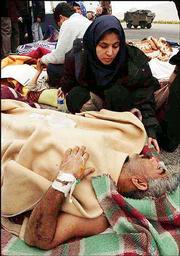 Iranians injured in Friday's earthquake wait for assistance in
Kerman airport, Iran. International relief crews started to arrive
Saturday in the region of Bam. Officials estimate that 30,000
people were injured.