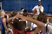 KU junior Keith Langford talks to children during the Jayhawks'
holiday hoops clinic. About 500 youngsters attended Saturday at
Allen Fieldhouse.