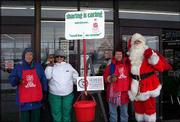 From left, Jean Lominska, Shirley Halladay, Lori Michel and Larry
Kline, as Santa, volunteer their time to be bell ringers for the
Salvation Army. The members of Altrusa International of Lawrence
rang the bells Dec. 13 at Checkers Foods, 2300 La.