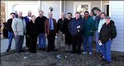 Habitat for Humanity church liaisons and their pastors gathered
Dec. 20 for the dedication of a house near 17th and Harper streets
sponsored by the churches. From left are Kent Tomlinson, the Rev.
Lew Hinshaw, John Harris, the Rev. Amanda Larsen, the Rev. Randy
Beeman, the Rev. Don Miller, Delmer Kruse, the Rev. Gary Teske, the
Rev. Jim Shaughnessy, Steve Ramirez, Steve Hillmer, the Rev. Jeff
Lilley and Dick Stumbo. The house is Habitat for Humanity's 53rd in
Lawrence. Twelve Lawrence churches were involved in the project.