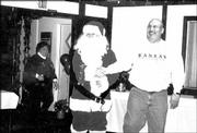 Grand Knight John Callewaert, as Santa, greets Deputy Grand Knight
Tony Augusto at the Knights of Columbus annual children's Christmas
party. The party was Dec. 6 at the Knights of Columbus, 2206 E.
23rd St.