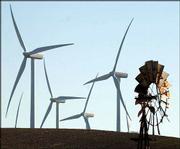 An old windmill, right, shares space with new, state-of-the-art
windmills in Birds Landing, Calif. A forest of 300-foot-high
turbines spins electricity for a half a dozen California cities on
the wind farm in rural Solano County, between San Francisco and
Sacramento.