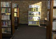 The "Staff Favorites" bookshelf in the children's section at the
Lawrence Public Library formerly contained books that were
favorites of Leslie Whittington, who died in the Sept. 11, 2001,
terrorist attacks. The "Leslie's Books" shelf was a gift from
Centennial School, which Whittington attended as a child.