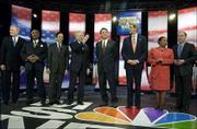Democratic presidential hopefuls, from left, Dick Gephardt, Al
Sharpton, Dennis Kucinich, Joe Lieberman, John Edwards, John Kerry,
Carol Moseley Braun and Howard Dean line up before the start of the
Brown and Black Forum in Des Moines, Iowa. Dean came under fire
during Sunday's debate for not hiring minorities to his Cabinet
during his tenure as Vermont governor.
