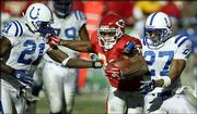 Kansas City running back Priest Holmes, center, fights off
Indianapolis defenders David Macklin, right, and Walt Harris.
Holmes fumbled on the play, and Macklin recovered for the Colts.
The play proved costly for the Chiefs in a 38-31 loss Sunday in
Kansas City, Mo.