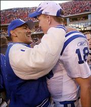 Indianapolis coach Tony Dungy, left, and quarterback Peyton Manning
congratulate each another following their 38-31 AFC playoff victory
Sunday at Arrowhead Stadium in Kansas City, Mo.