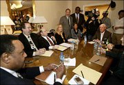 Michael Jackson's music manager, Charles Koppelman, seated at the
head of the table at right, with defense lawyer Mark Geragos,
standing at left, and Nation of Islam chief of staff Leonard
Muhammad, seated far left, along with Jackson's closest advisers
have an all-day meeting Monday at the Beverly Hills Hotel in
Beverly Hills, Calif., to discuss the singer's legal and financial
strategy. Jackson is scheduled to be arraigned Friday in Santa
Maria, Calif., on child molestation charges.