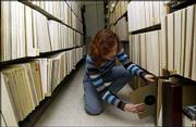 Roberta Freund Schwartz, assistant professor of historical
musicology and manager of KU's Archive of Recorded Sound, shelves a
priceless opera recording. Inset at right shows a closeup of one of
the unusual albums in the collection that includes detailed artwork
on the disc itself.